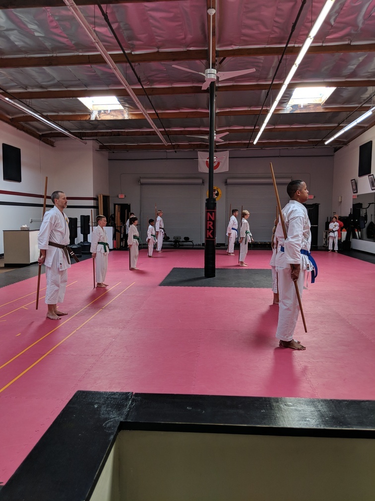 Growler (back row, foreground) preparing for a bo kata.