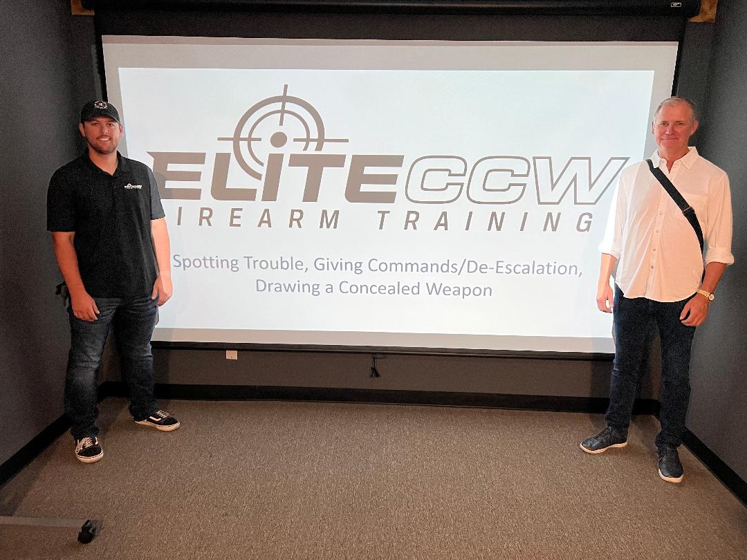 Bailey and the Karate Institute of America’s most recent Black Belt, Chip “Hawk” Robinson, pose together in one of EliteCCW’s training rooms, specifically, the Simulator room.